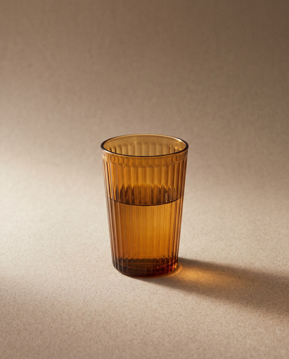 Ribbed amber glass tumbler